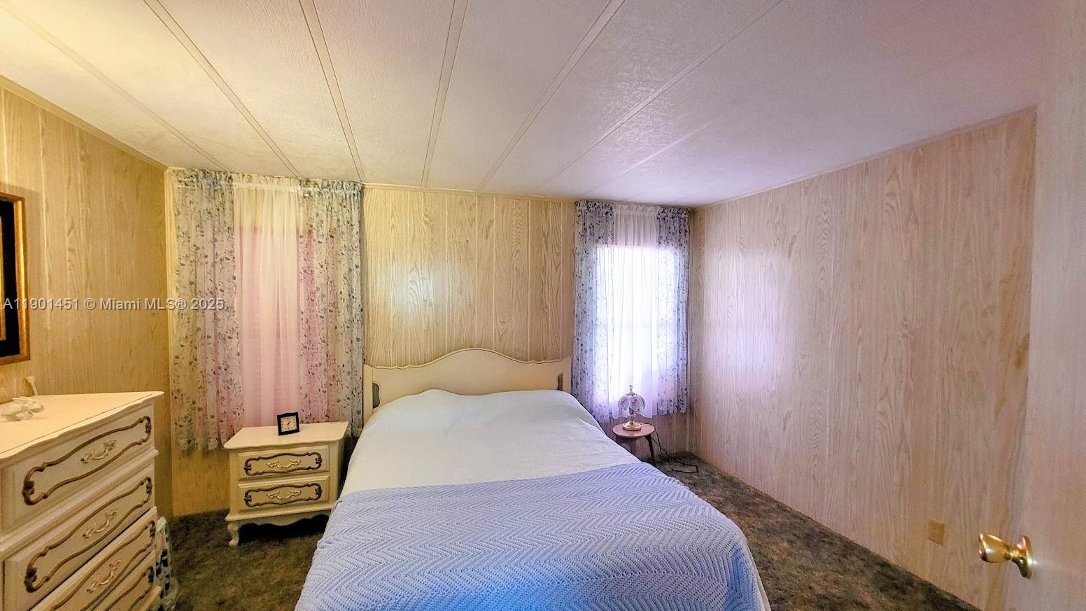 10 Hay Alva, FL 33920 - Photo 12 of 14 a bedroom with a bed and a chandelier