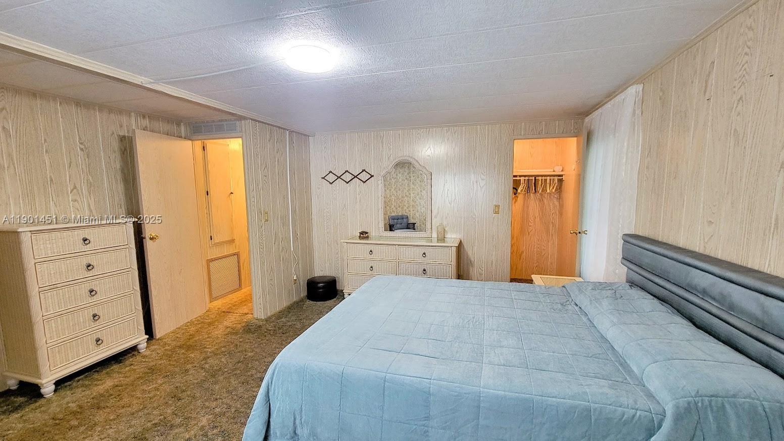 10 Hay Alva, FL 33920 - Photo 13 of 14 a large white bed in a white room with closet and mirror