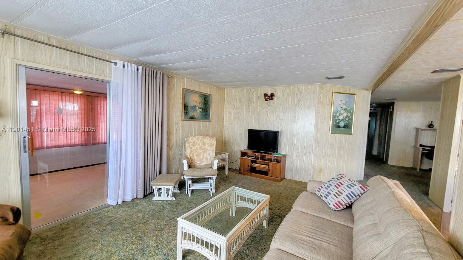 10 Hay Alva, FL 33920 - Photo 6 of 14 a living room with furniture and a flat screen tv