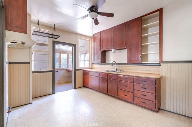 a kitchen with stainless steel appliances granite countertop a refrigerator a sink dishwasher a stove with wooden cabinets and floor