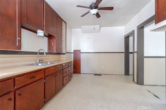 a kitchen with refrigerator a sink and cabinets