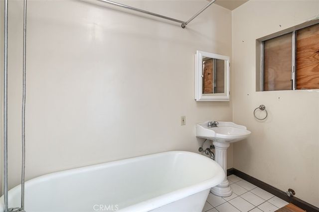 a bathroom with a white bath tub and a shower curtain