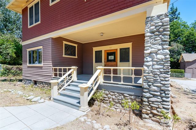 a front view of a house with a large window