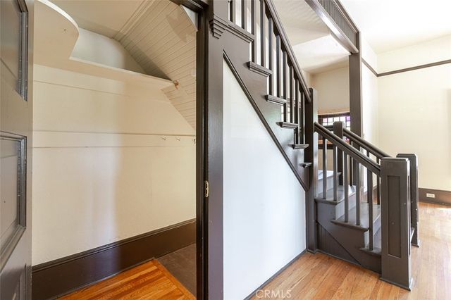 a view of entryway with wooden floor and stairs