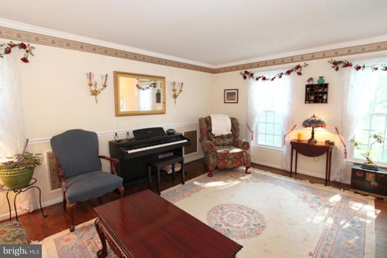 12504 Arbor View Terrace Silver Spring, MD 20902 - Photo 7 of 18 a living room with furniture a piano and a window