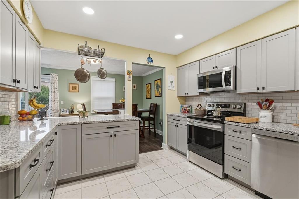 2356 Big Rock Road Allison Park, PA 15101 - Photo 12 of 31 a kitchen with stainless steel appliances granite countertop a stove and cabinets