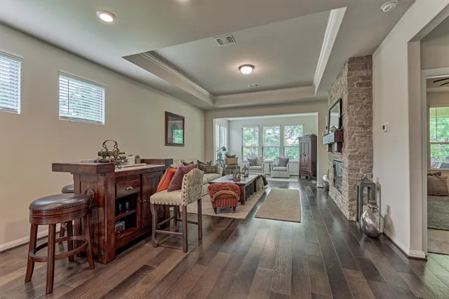 a living room with furniture wooden floor and a fireplace