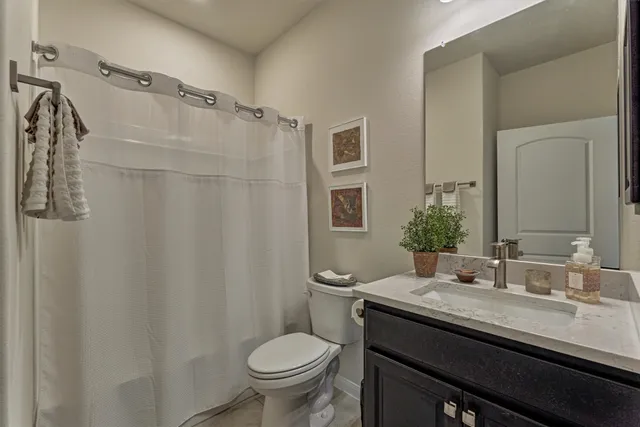 a living room with furniture a flat screen tv and a large window