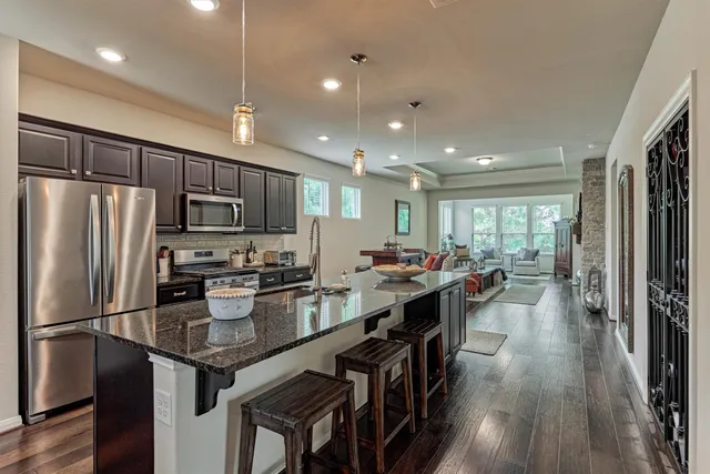 a kitchen with counter top space a sink appliances and cabinets
