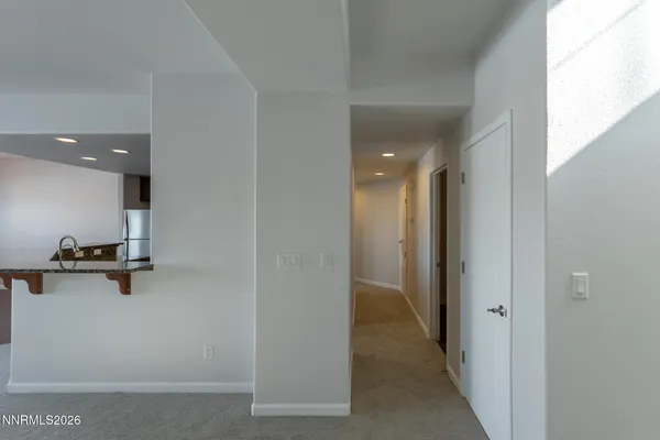 a view of a livingroom with a ceiling fan and window