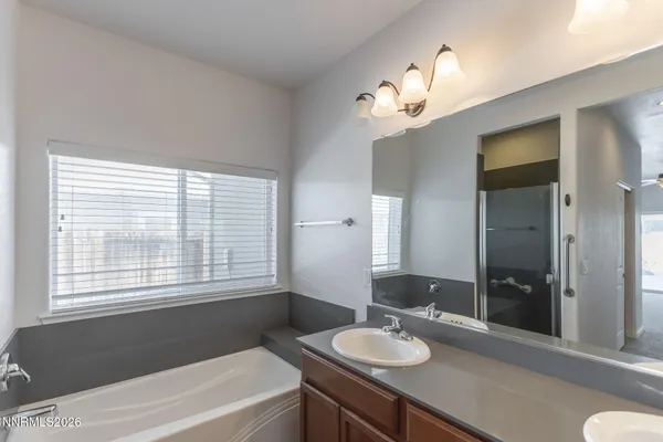 a bathroom with a glass door shower a sink and a mirror