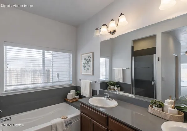 a bathroom with a tub a double vanity sink and a mirror