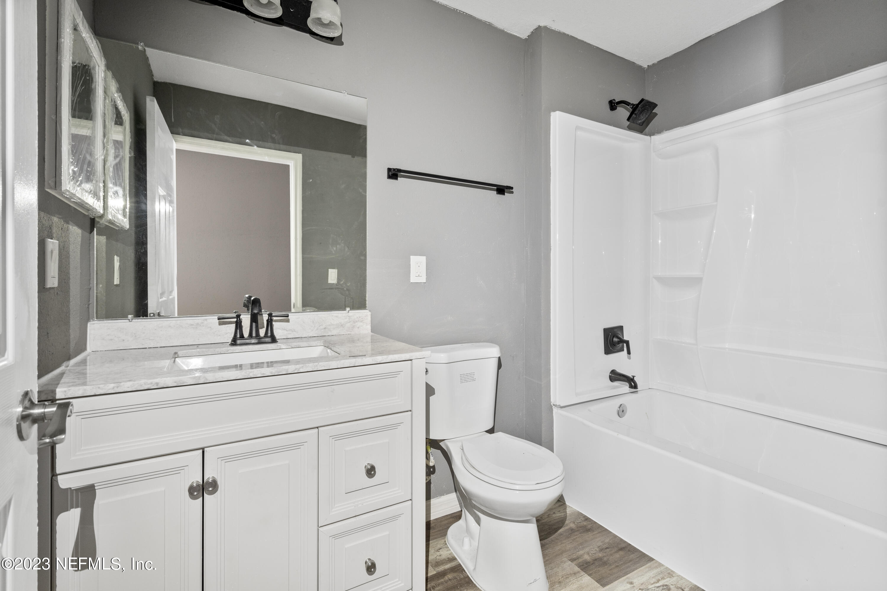 221 Monterey Boulevard Baldwin, FL 32234 - Photo 13 of 18 a bathroom with a sink a toilet and a mirror