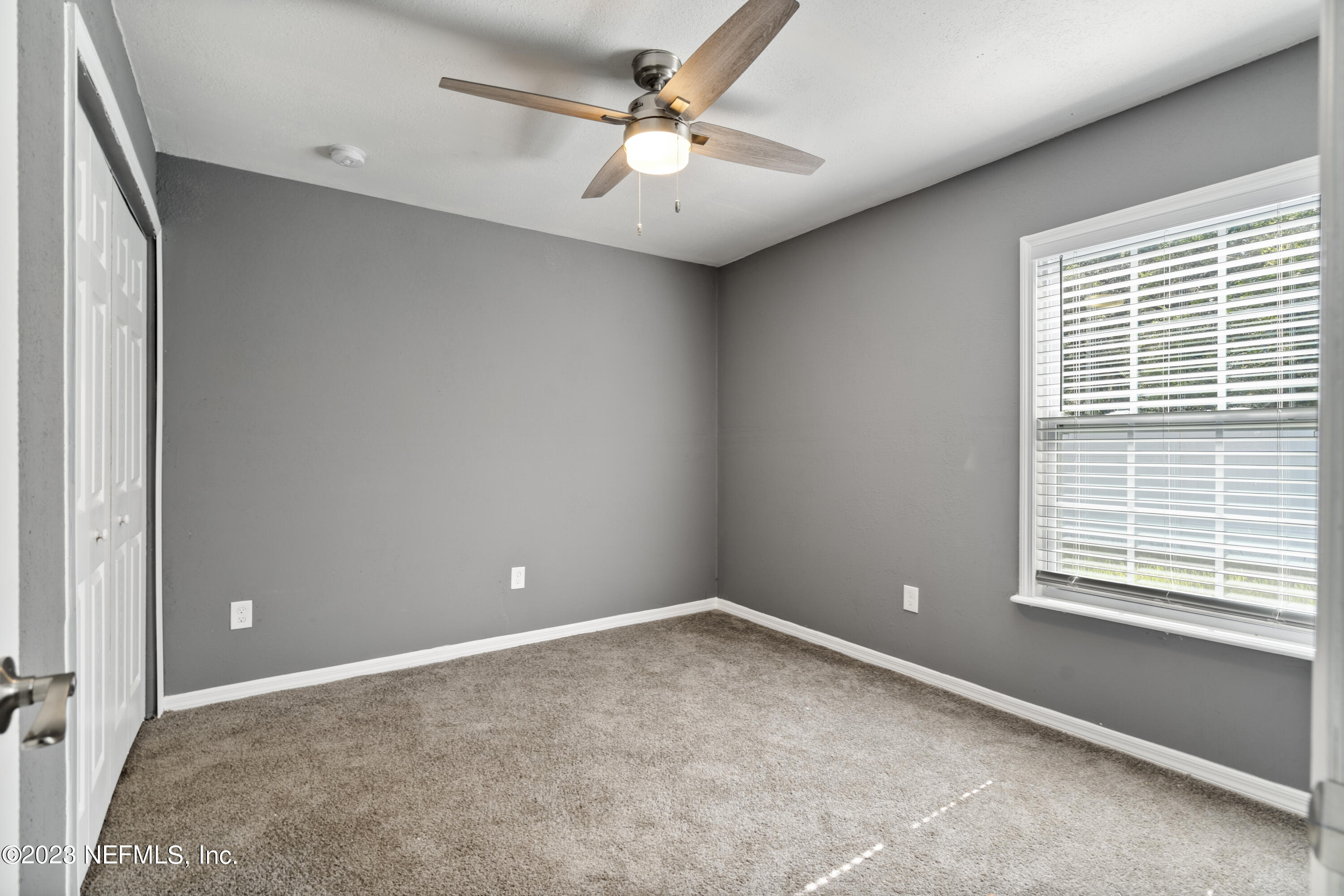 221 Monterey Boulevard Baldwin, FL 32234 - Photo 14 of 18 a view of a livingroom with a ceiling fan and window