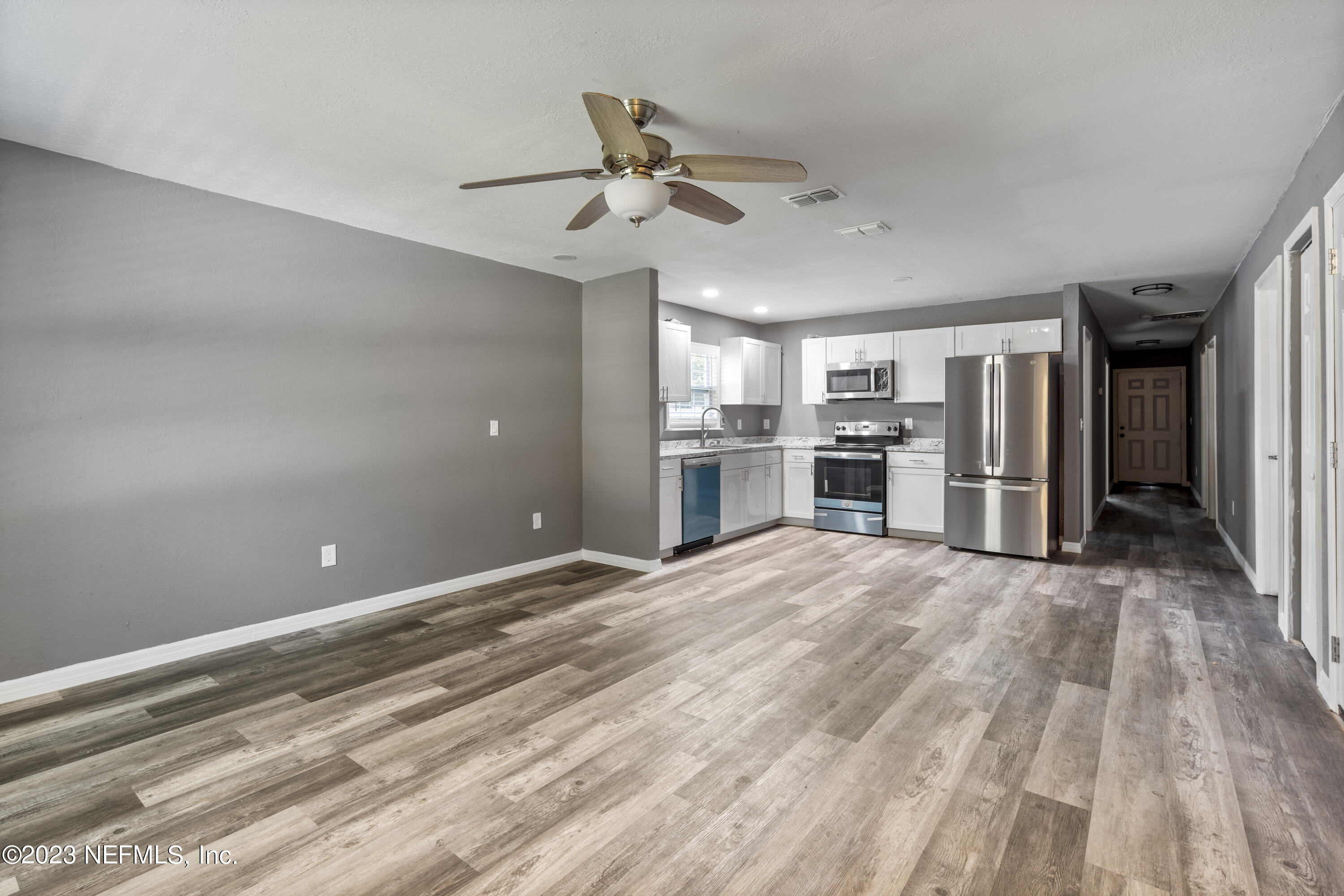 221 Monterey Boulevard Baldwin, FL 32234 - Photo 6 of 18 a view of empty room with wooden floor and ceiling fan