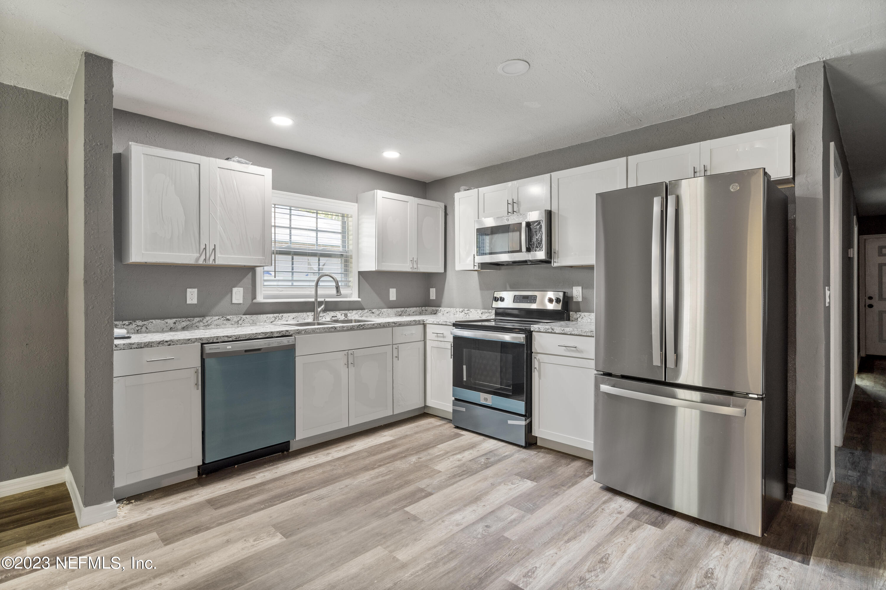 221 Monterey Boulevard Baldwin, FL 32234 - Photo 7 of 18 a kitchen with a refrigerator stove and sink