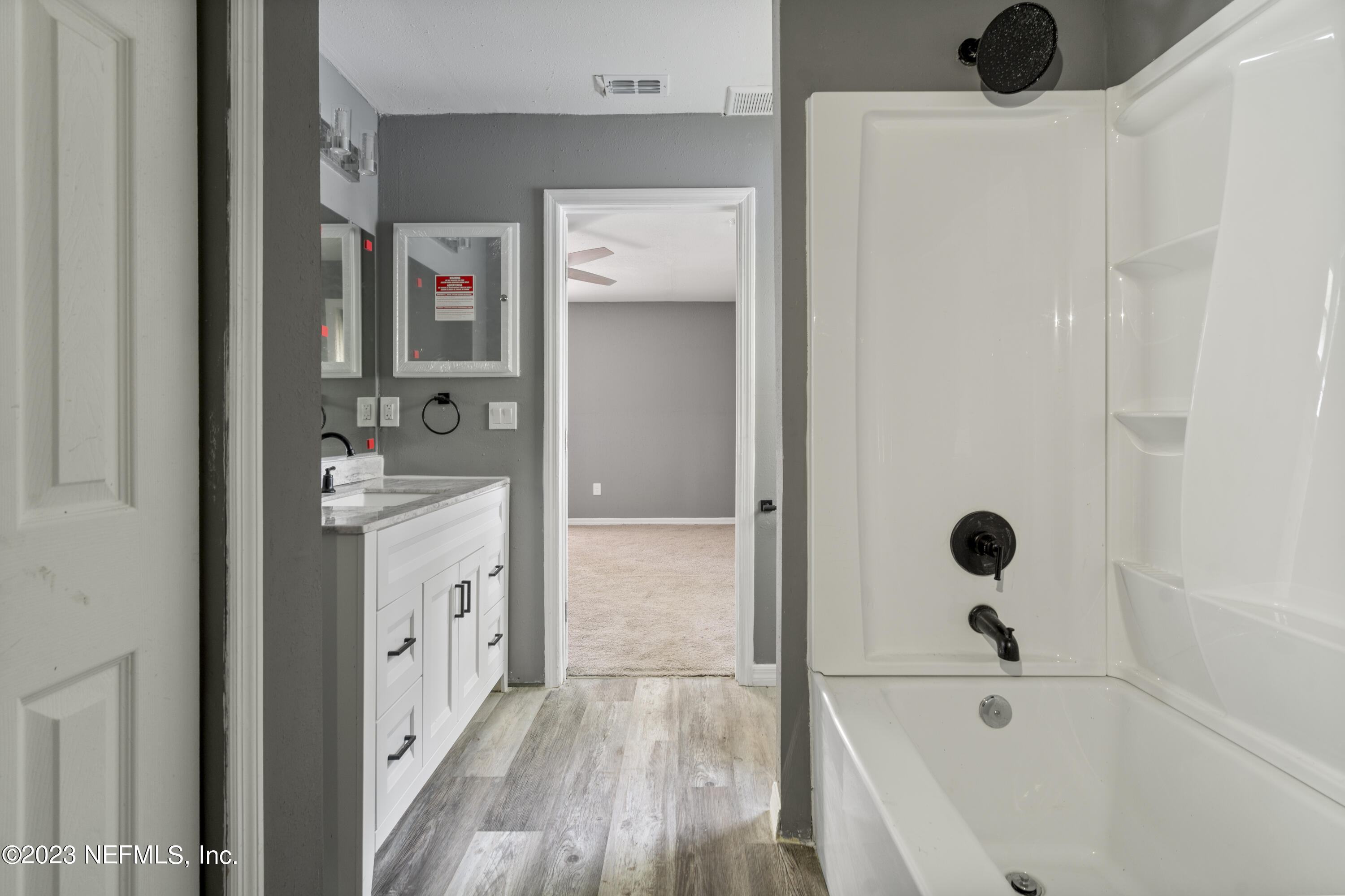221 Monterey Boulevard Baldwin, FL 32234 - Photo 9 of 18 a bathroom with a tub sink and mirror