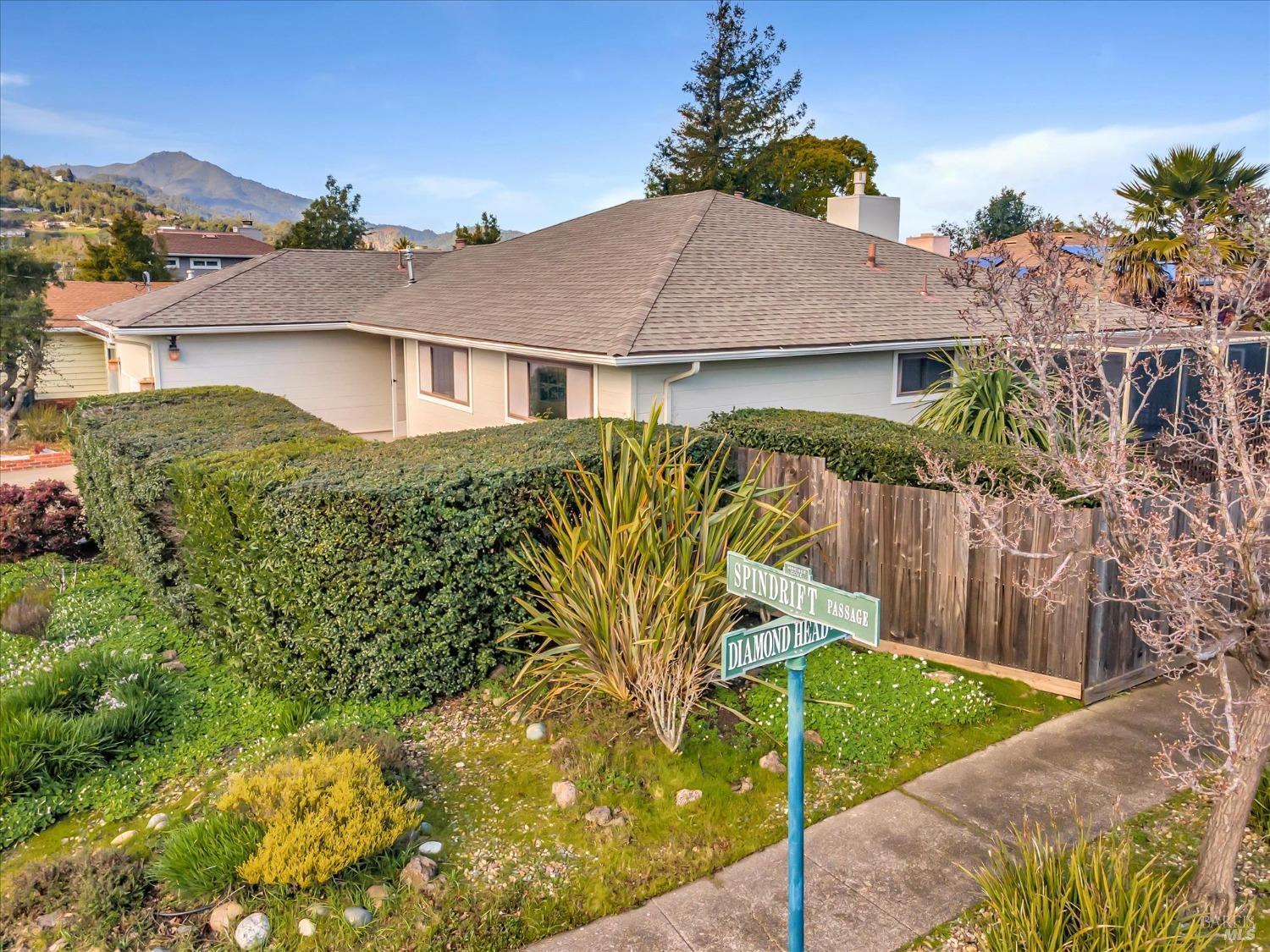 62 Spindrift Passage Corte Madera, CA 94925 - Photo 1 of 1 a view of a white house next to a yard with flower plants