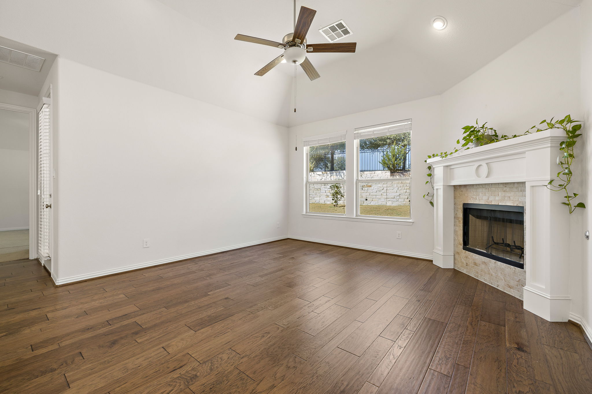 4201 Vespa Cove Leander, TX 78641 - Photo 4 of 29 a view of an empty room with a fireplace and a window