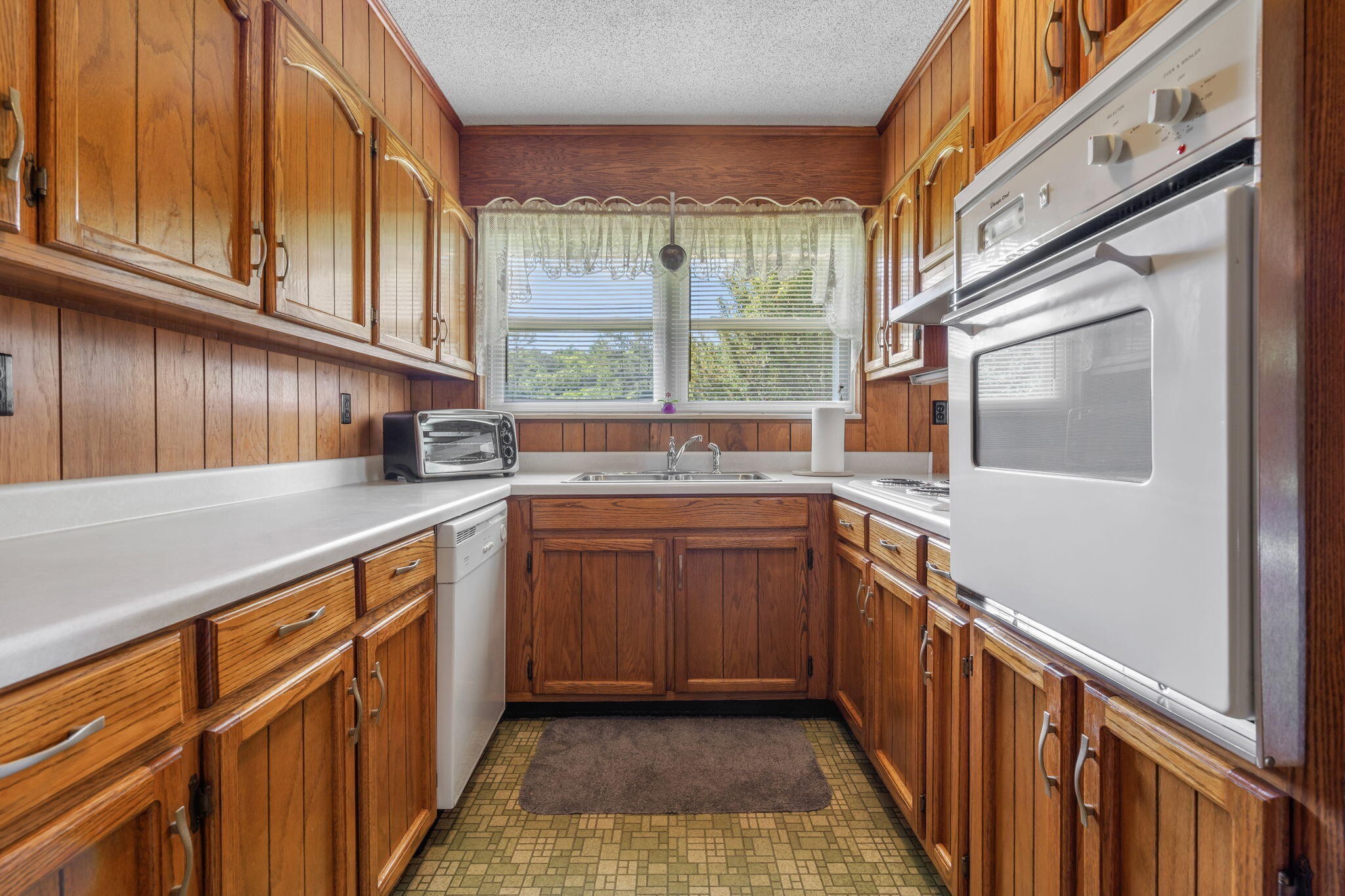415 Parksville Road Benton, TN 37307 - Photo 3 of 34 a kitchen with stainless steel appliances granite countertop a sink and a stove next to a window