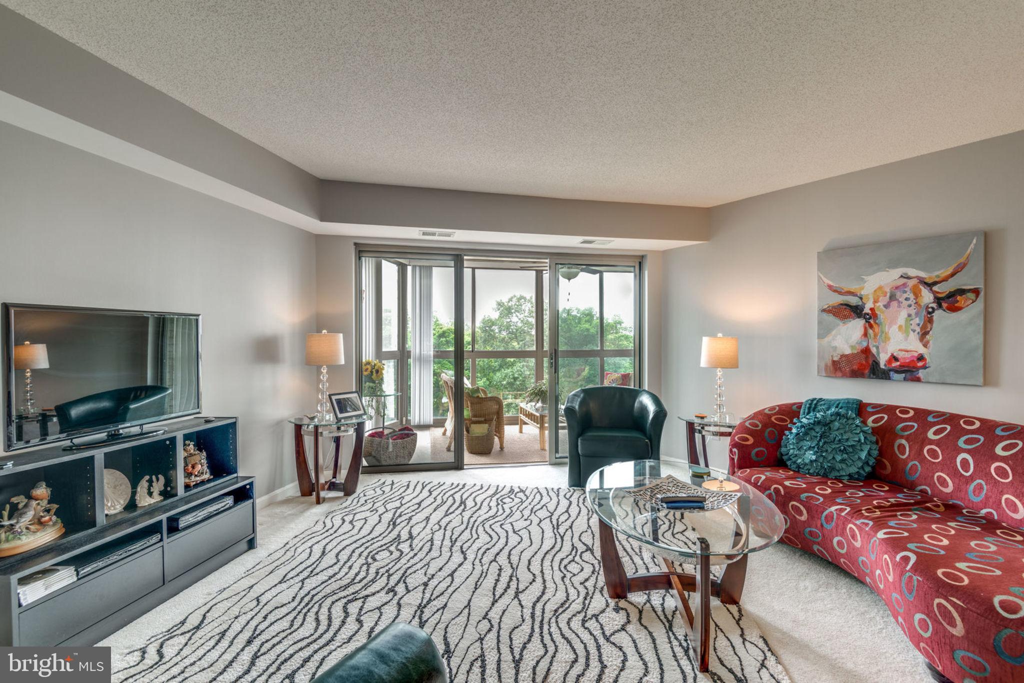 19385 Cypress Ridge Terrace, Unit 721 Leesburg, VA 20176 - Photo 2 of 26 Spacious living area with sliding doors to sunroom