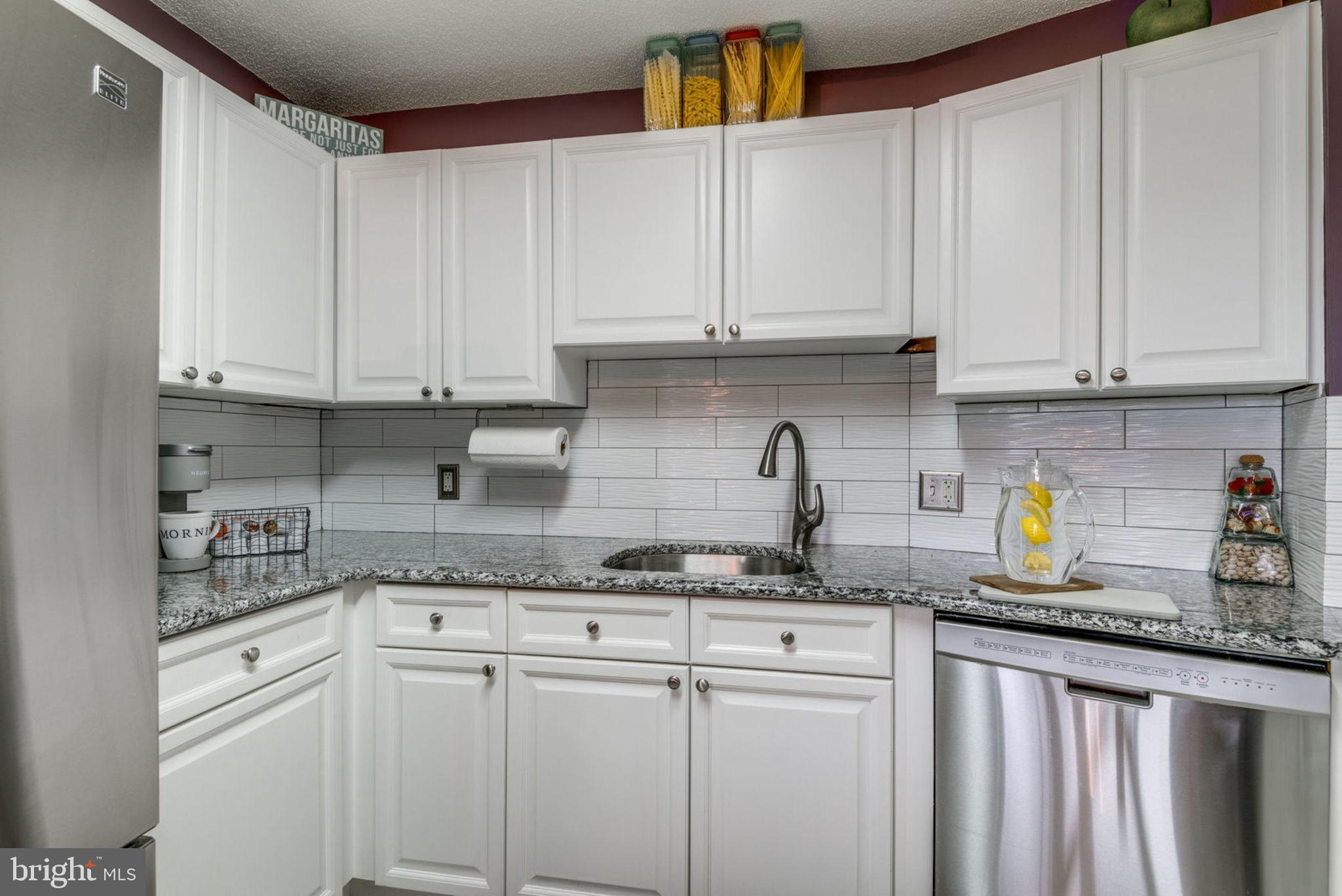 19385 Cypress Ridge Terrace, Unit 721 Leesburg, VA 20176 - Photo 9 of 26 Beautiful tile backsplash