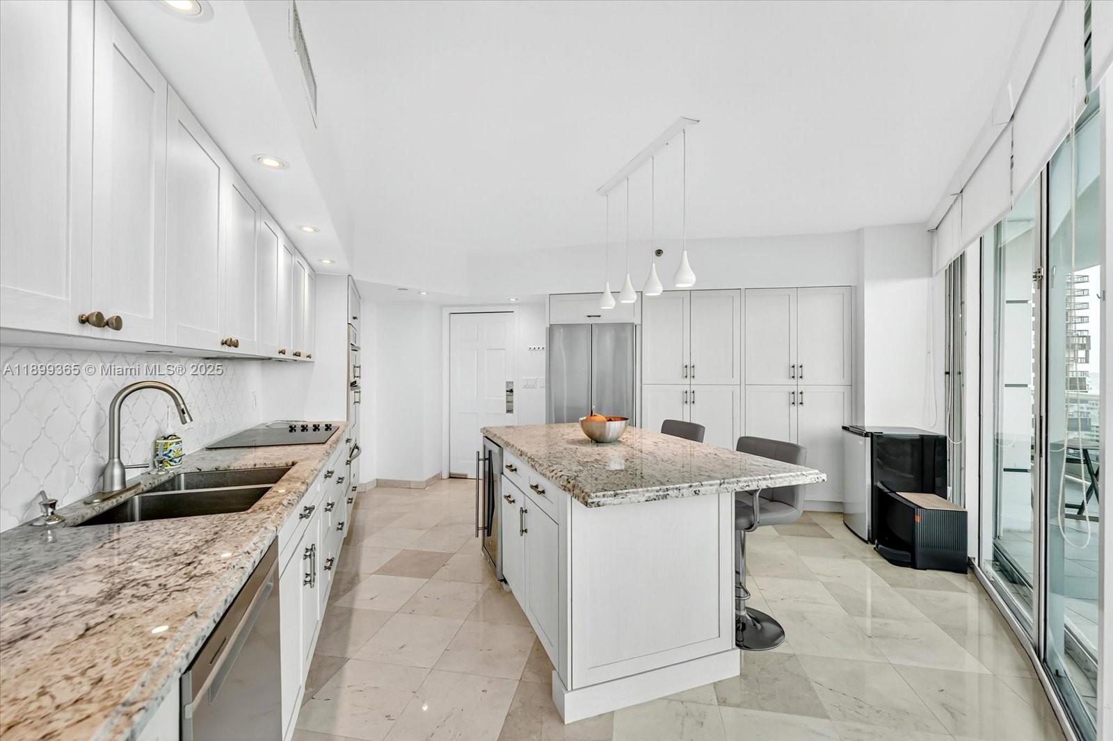2127 Brickell Avenue, Unit 2005 Miami, FL 33129 - Photo 16 of 53 a kitchen with stainless steel appliances granite countertop a sink stove and refrigerator
