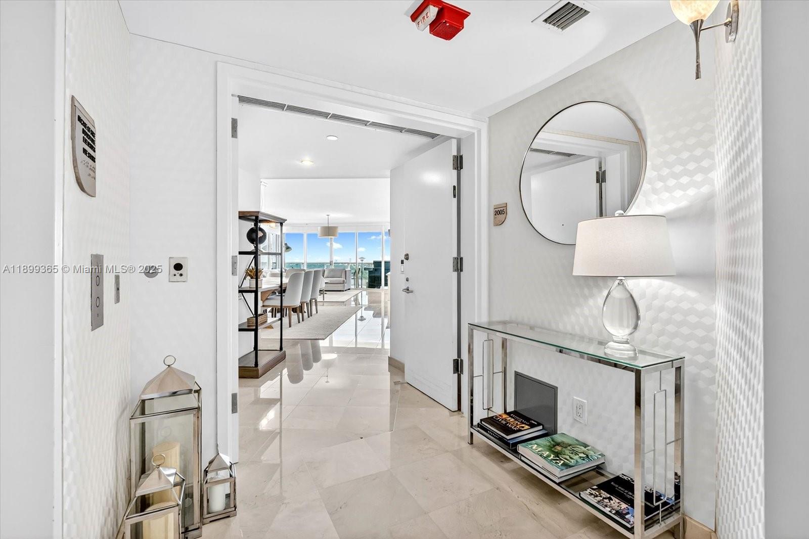 2127 Brickell Avenue, Unit 2005 Miami, FL 33129 - Photo 20 of 53 a kitchen with stainless steel appliances kitchen island a refrigerator and a stove
