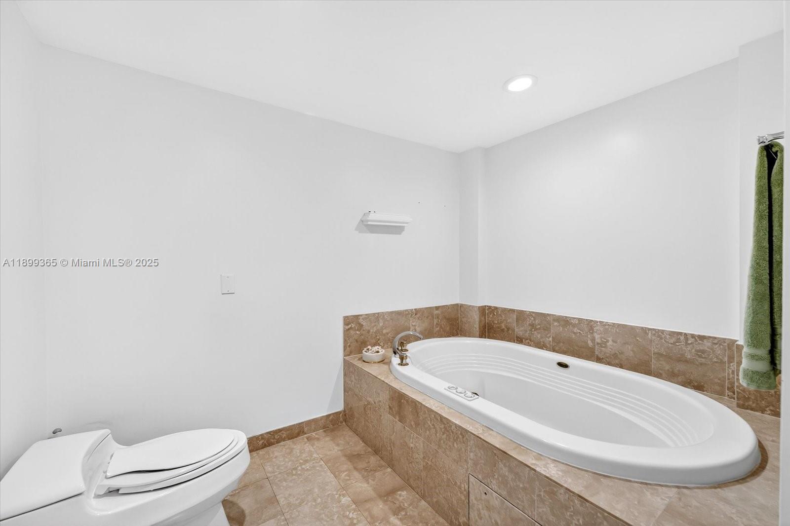 2127 Brickell Avenue, Unit 2005 Miami, FL 33129 - Photo 30 of 53 a bathroom with a white bath tub and toilet