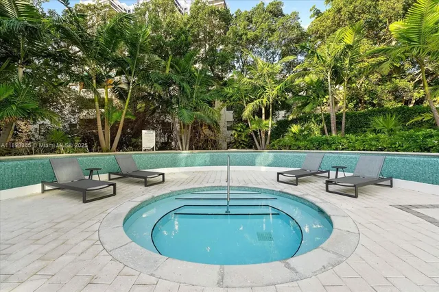 a swimming pool with outdoor seating and yard