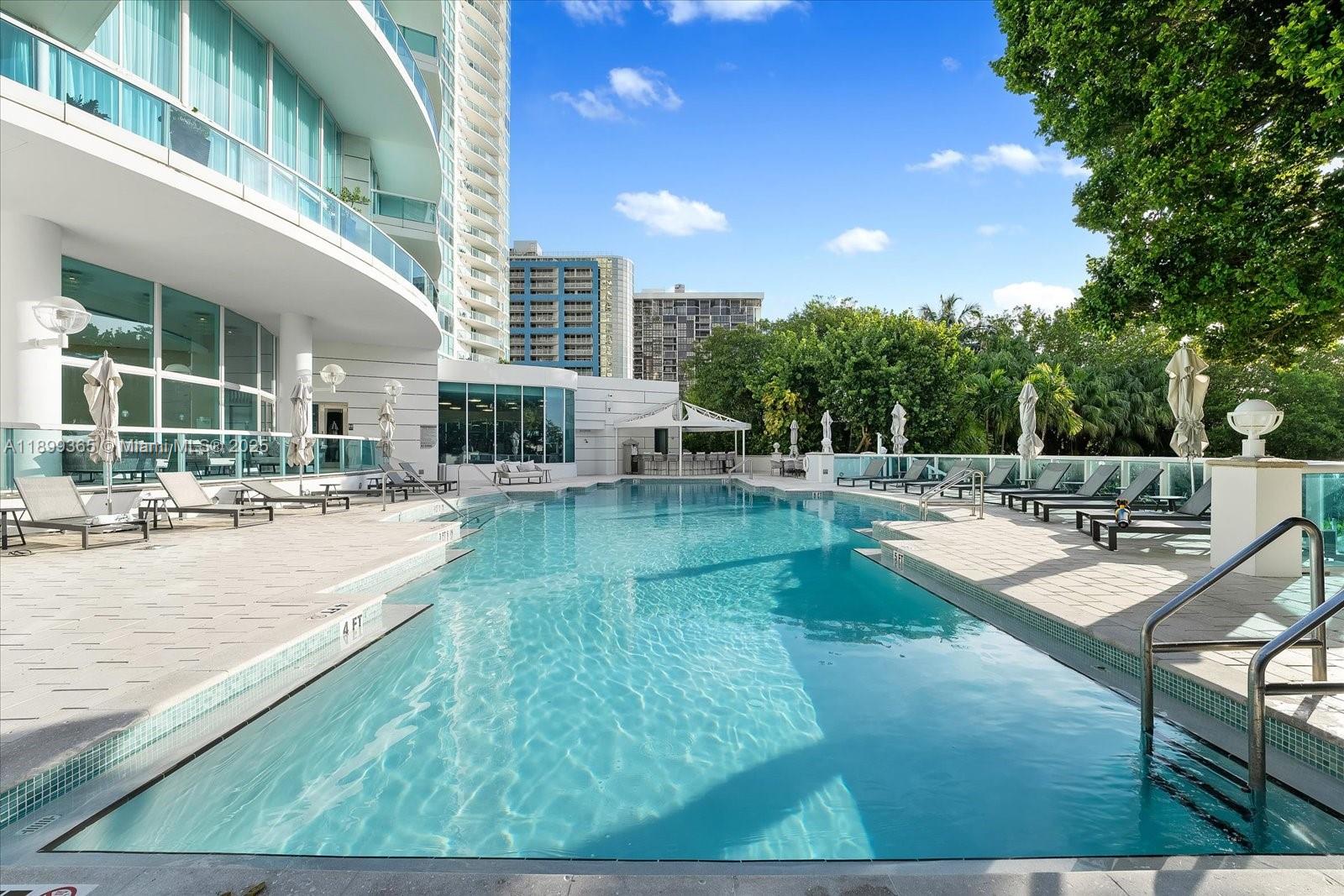 2127 Brickell Avenue, Unit 2005 Miami, FL 33129 - Photo 40 of 53 a swimming pool with outdoor seating and yard