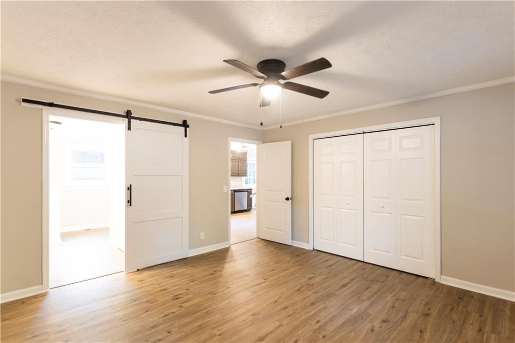 1149 Criswell Road Southeast Monroe, GA 30655 - Photo 14 of 60 a view of an empty room with wooden floor