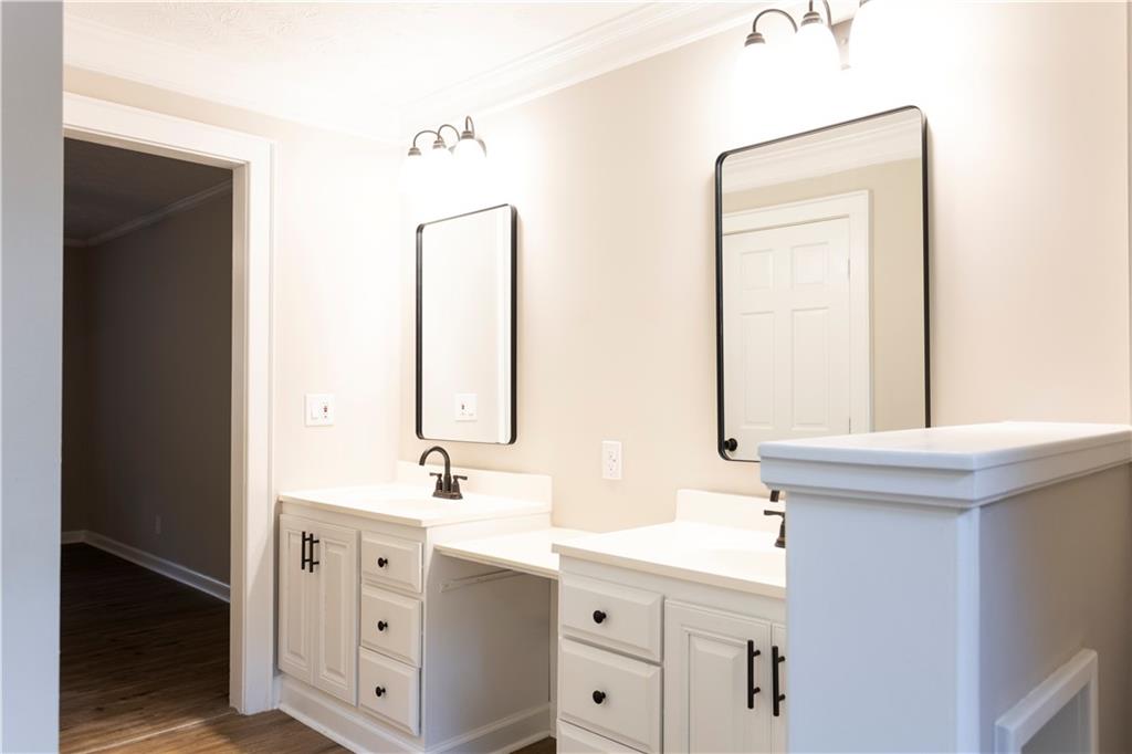 1149 Criswell Road Southeast Monroe, GA 30655 - Photo 16 of 60 a bathroom with a sink a vanity and a mirror