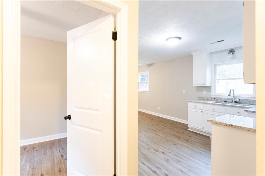 1149 Criswell Road Southeast Monroe, GA 30655 - Photo 17 of 60 a view of a kitchen with a sink and wooden floor