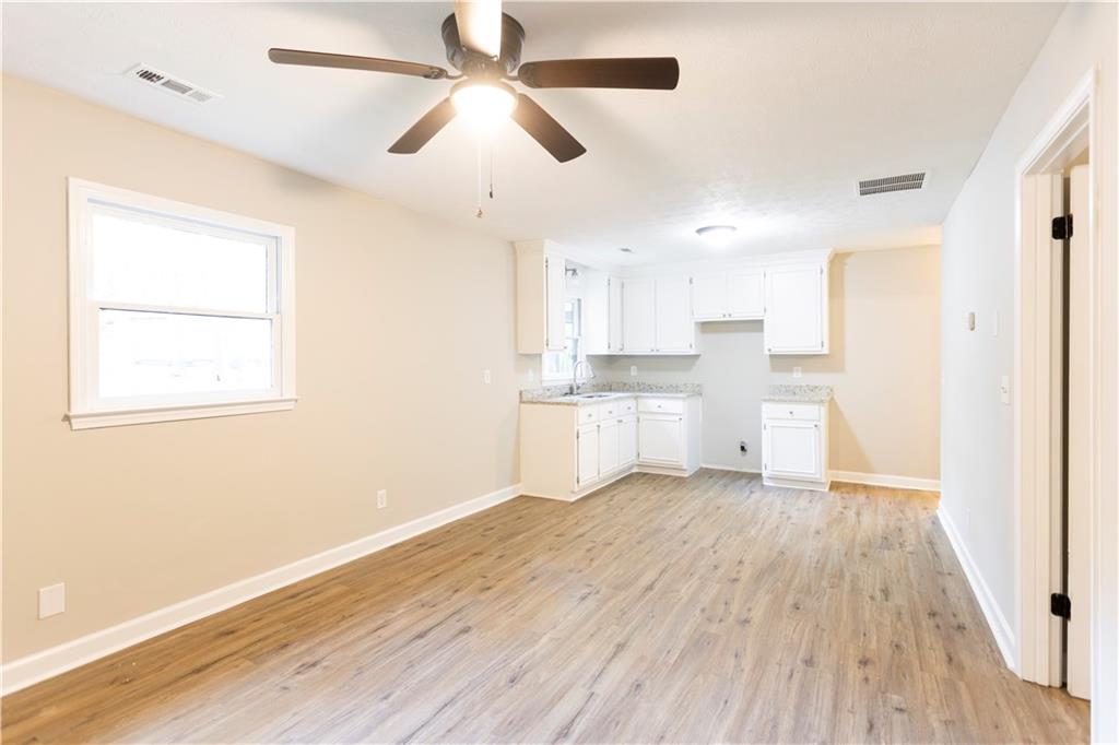 1149 Criswell Road Southeast Monroe, GA 30655 - Photo 20 of 60 a view of kitchen with wooden floor electronic appliances and window