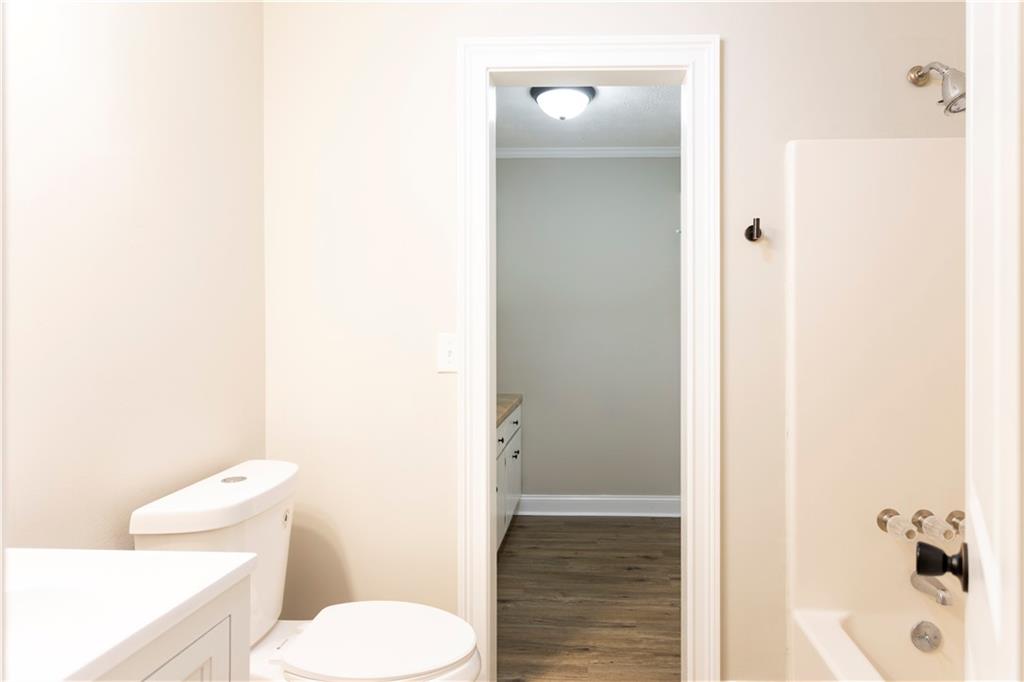 1149 Criswell Road Southeast Monroe, GA 30655 - Photo 21 of 60 a white toilet sitting next to a bathroom sink