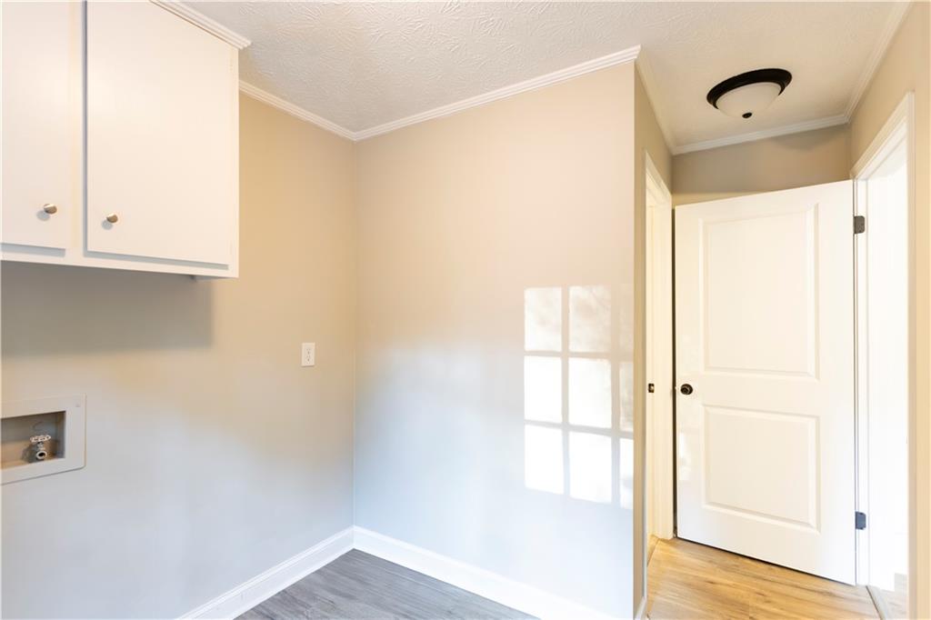 1149 Criswell Road Southeast Monroe, GA 30655 - Photo 25 of 60 a view of an empty room with wooden floor