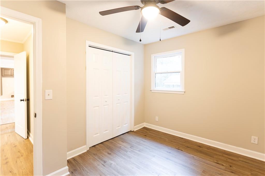 1149 Criswell Road Southeast Monroe, GA 30655 - Photo 29 of 60 a view of an empty room with wooden floor and a window