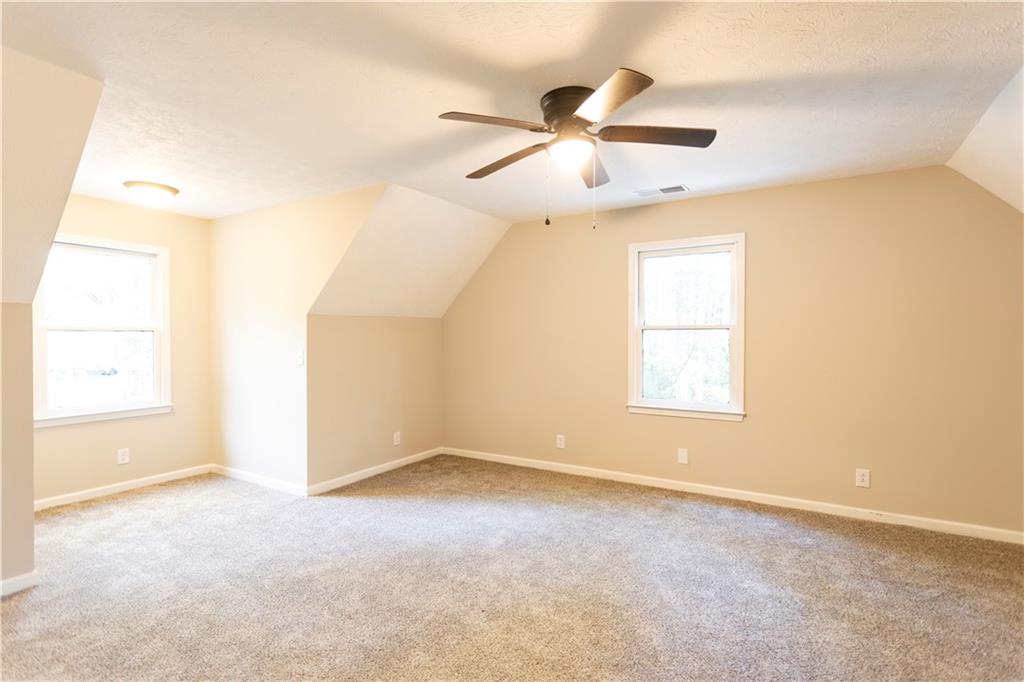 1149 Criswell Road Southeast Monroe, GA 30655 - Photo 33 of 60 an empty room with windows and fan