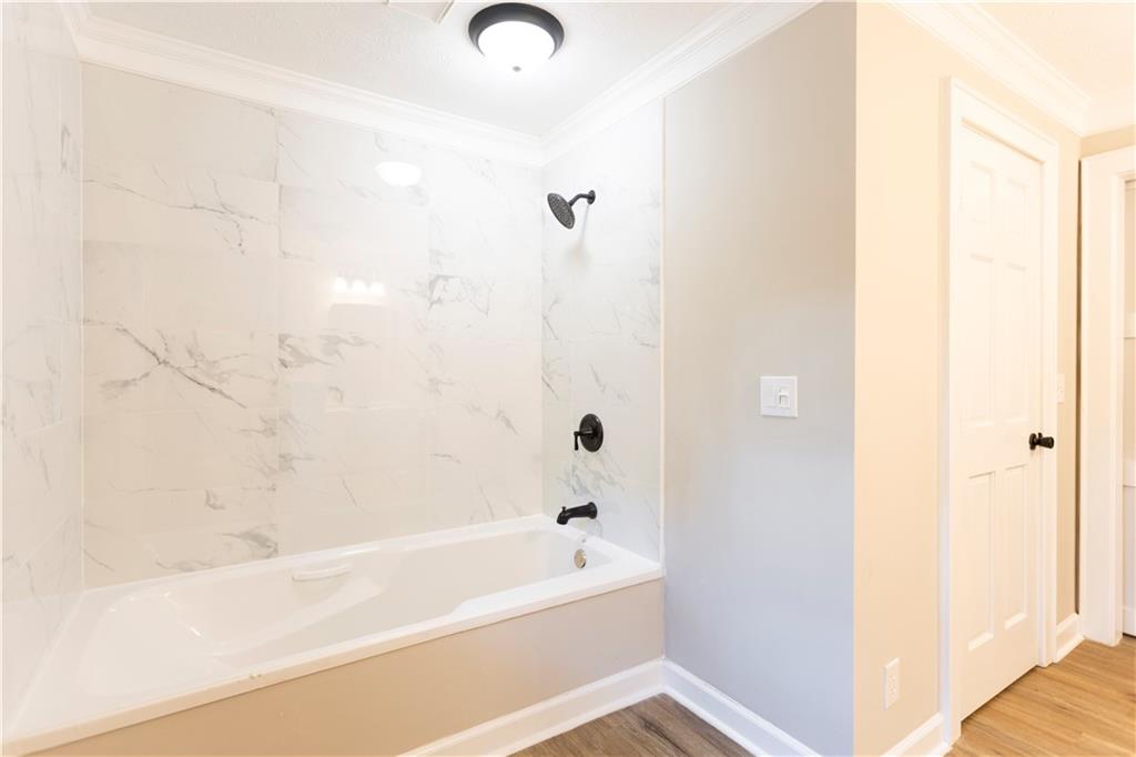 1149 Criswell Road Southeast Monroe, GA 30655 - Photo 37 of 60 a bathroom with a bathtub and shower