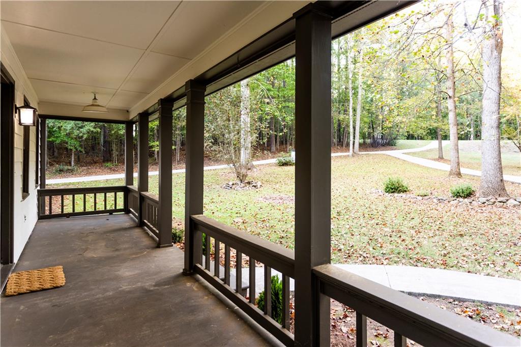 1149 Criswell Road Southeast Monroe, GA 30655 - Photo 4 of 60 a view of a porch with wooden floor and fence