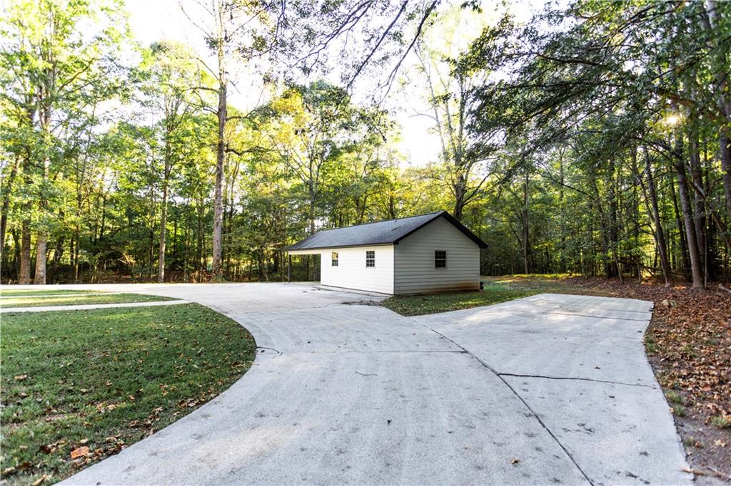 1149 Criswell Road Southeast Monroe, GA 30655 - Photo 44 of 60 a view of house with yard and trees in the background