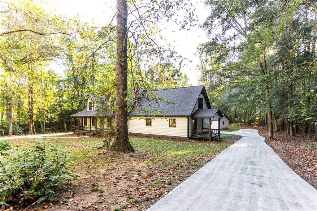 1149 Criswell Road Southeast Monroe, GA 30655 - Photo 46 of 60 a front view of a house with a yard and trees