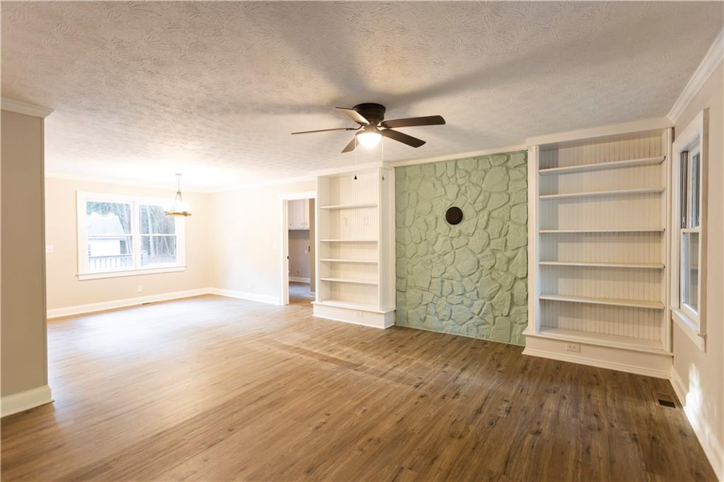 1149 Criswell Road Southeast Monroe, GA 30655 - Photo 5 of 60 a view of an empty room with a window and wooden floor