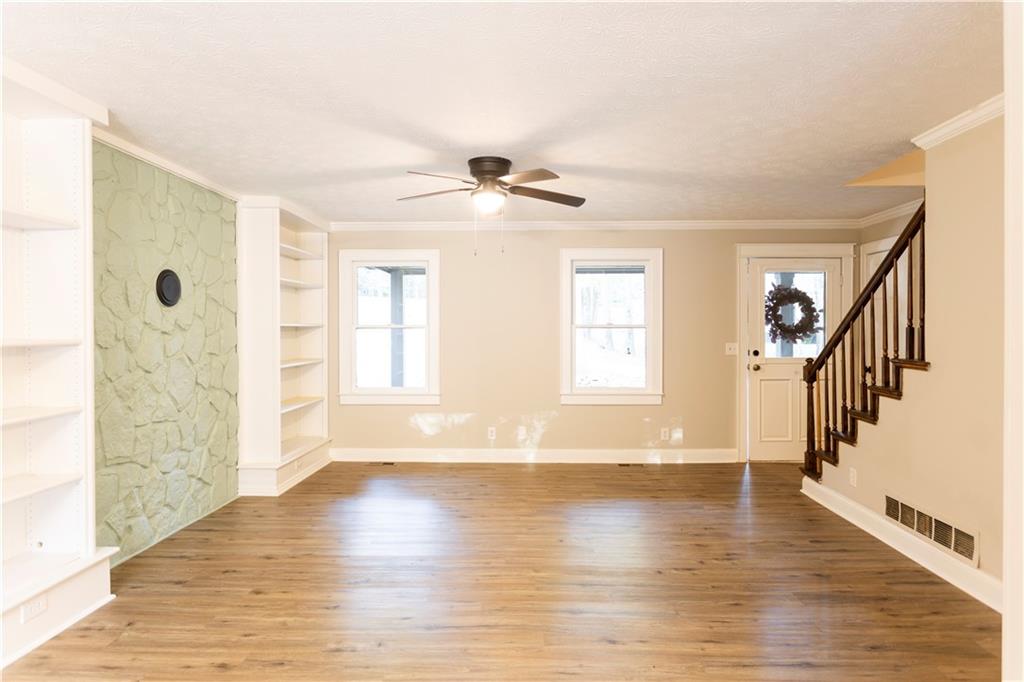 1149 Criswell Road Southeast Monroe, GA 30655 - Photo 7 of 60 a view of an empty room with wooden floor and a window