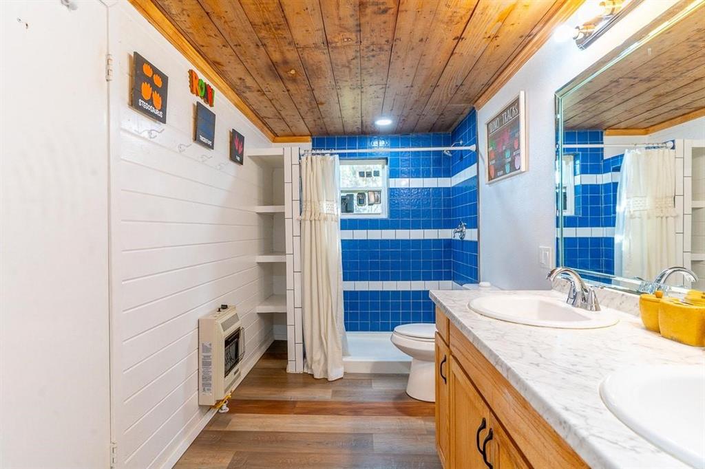 1025 Hcr 2421 Road Hillsboro, TX 76645 - Photo 13 of 36 a bathroom with a sink a toilet and shower