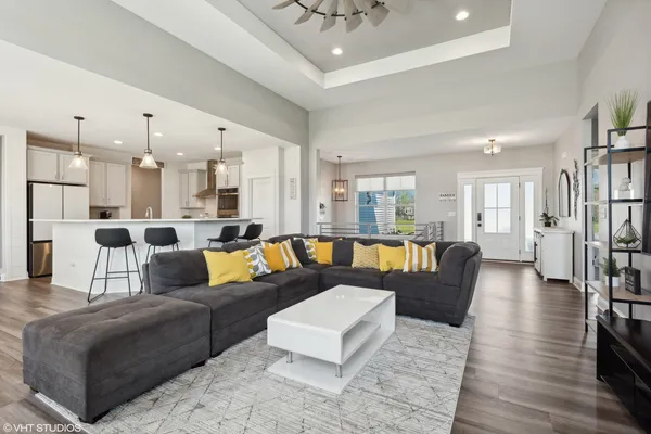 a living room with furniture and wooden floor