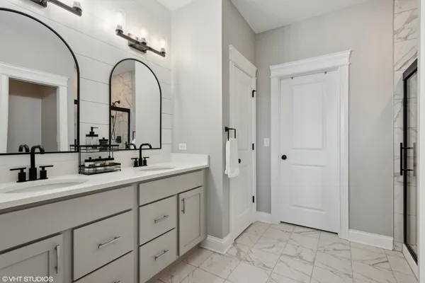 a bathroom with a double vanity sink and mirror