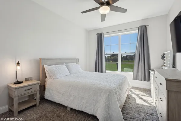 a bedroom with a large bed and a window