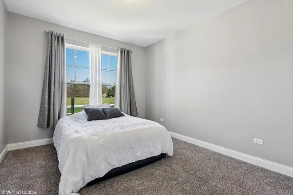 a bedroom with a bed and window